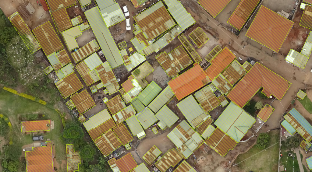 Top-down drone-captured image of African town with computer generated rectangles over building rooftops